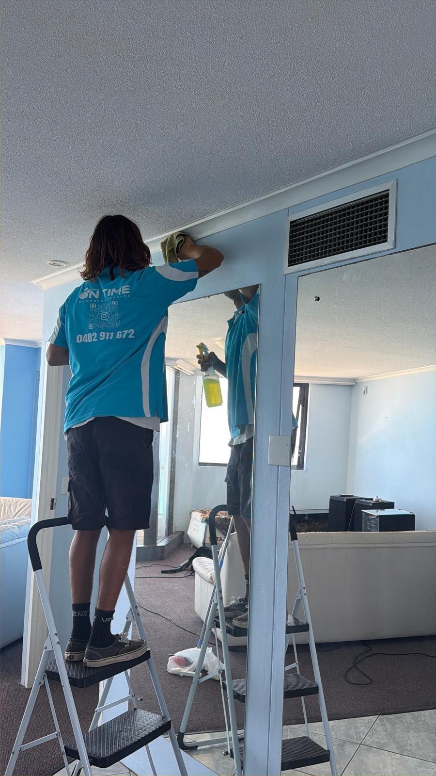 Blue On Time cleaner high dusting around air vent and mirrors on the Gold Coast