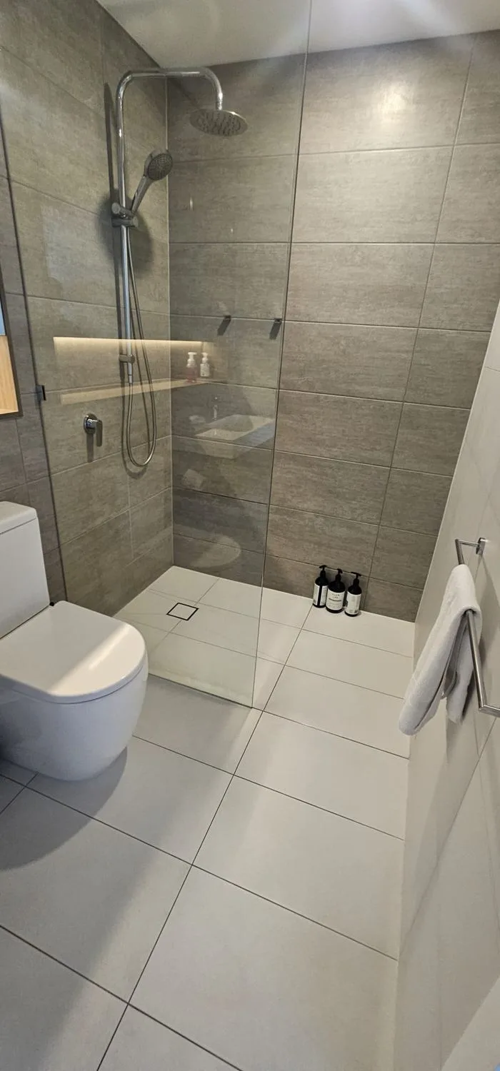 Clean shower recess and glass after bond cleaning in a Gold Coast apartment